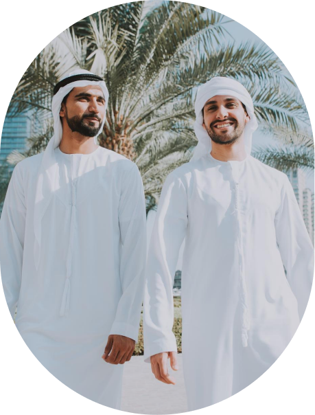 Two men in traditional Emirati dress standing outdoors in Dubai