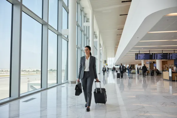 Business traveler walking through a modern airport terminal
